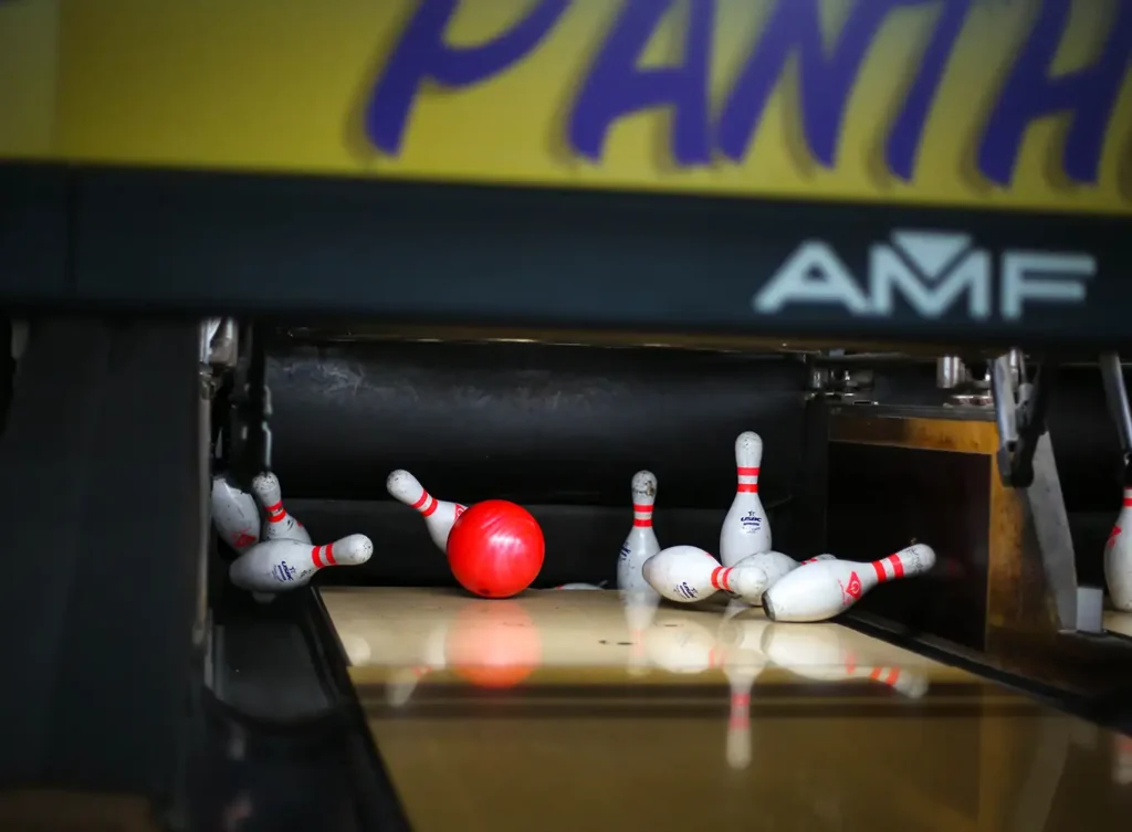 bowling knocking down pins