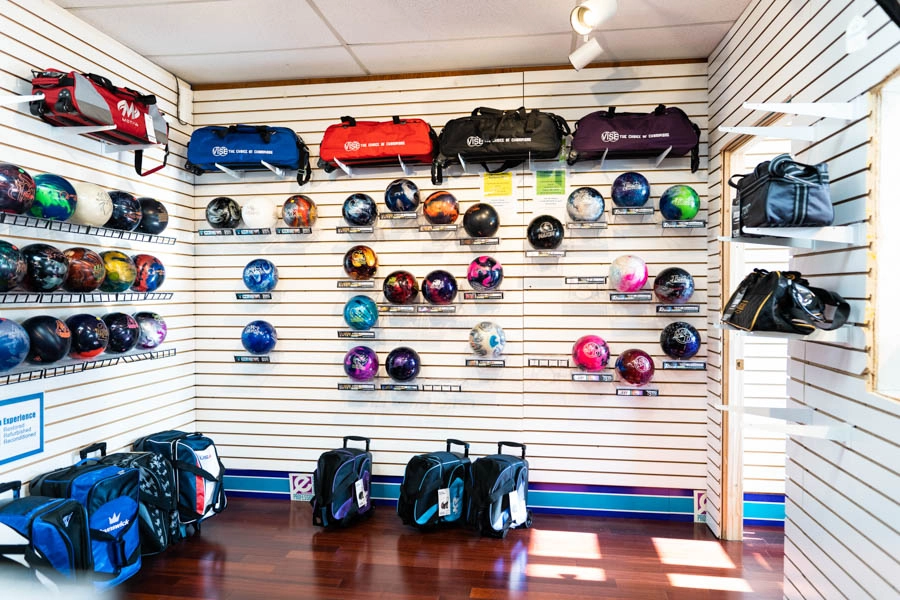 Bowling balls and equipment bags displayed inside the Bowlers' Shoppe at St. Clair Bowl