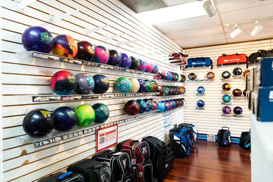 Rows of colorful bowling balls and bowling bags for sale in the Bowlers' Shoppe