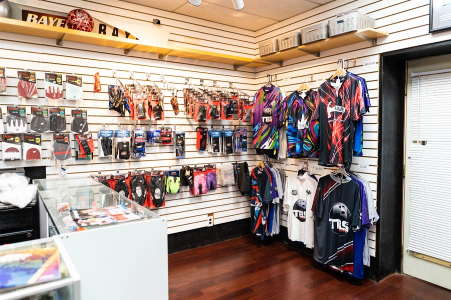 Bowling accessories, apparel, and jerseys displayed inside the Bowlers' Shoppe