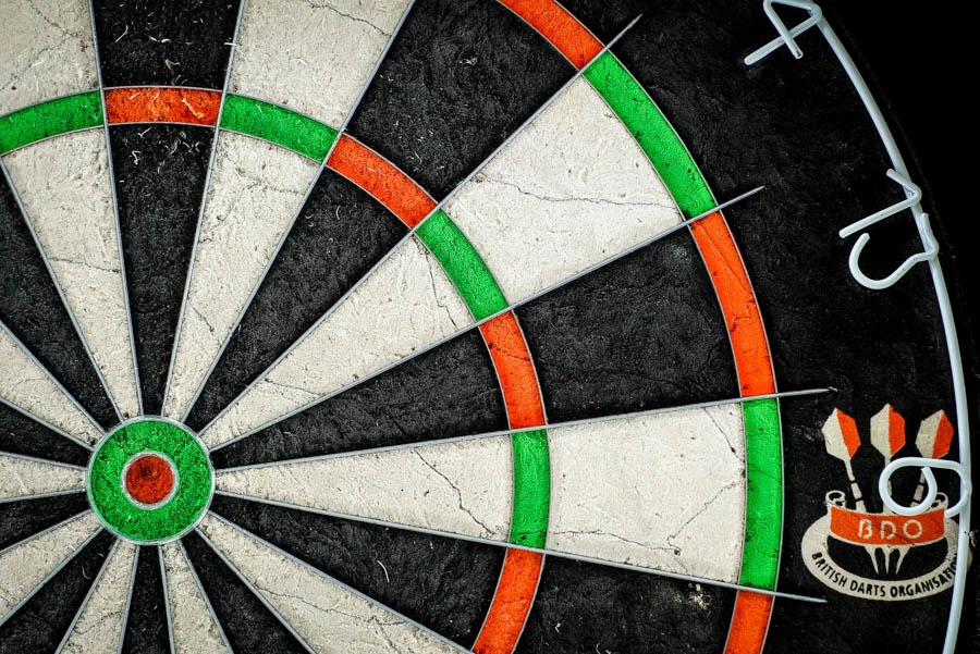 Close-up of darts on a traditional dartboard