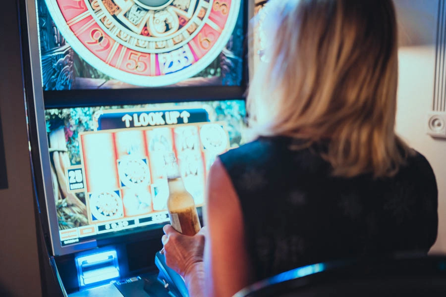 Woman playing an electronic gaming machine at Trixie’s Gaming Parlor