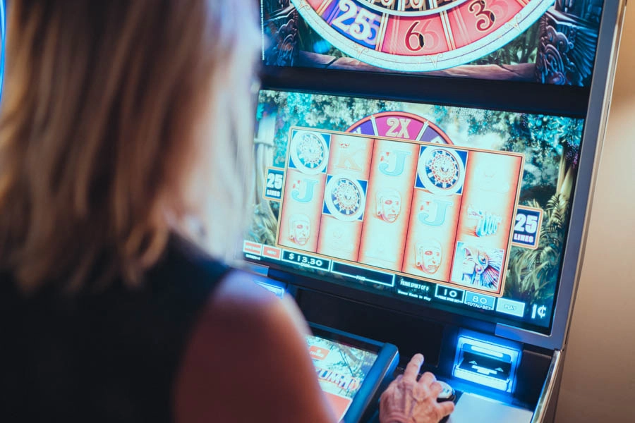 Close-up of a woman playing an electronic gaming machine