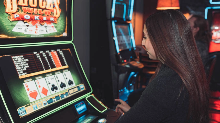 Woman playing a colorful touchscreen gaming machine